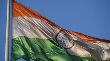 India flag flying high at Connaught Place with pride in blue sky, India flag fluttering, Indian Flag on Independence Day and Republic Day of India, tilt up shot, Waving Indian flag, Har Ghar Tiranga