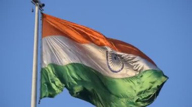 India flag flying high at Connaught Place with pride in blue sky, India flag fluttering, Indian Flag on Independence Day and Republic Day of India, tilt up shot, Waving Indian flag, Har Ghar Tiranga