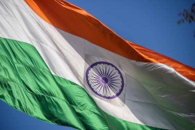 India flag flying high at Connaught Place with pride in blue sky, India flag fluttering, Indian Flag on Independence Day and Republic Day of India, tilt up shot, Waving Indian flag, Har Ghar Tiranga