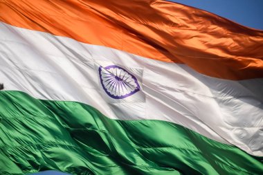 India flag flying high at Connaught Place with pride in blue sky, India flag fluttering, Indian Flag on Independence Day and Republic Day of India, tilt up shot, Waving Indian flag, Har Ghar Tiranga