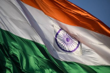 India flag flying high at Connaught Place with pride in blue sky, India flag fluttering, Indian Flag on Independence Day and Republic Day of India, tilt up shot, Waving Indian flag, Har Ghar Tiranga