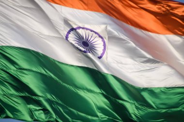 India flag flying high at Connaught Place with pride in blue sky, India flag fluttering, Indian Flag on Independence Day and Republic Day of India, tilt up shot, Waving Indian flag, Har Ghar Tiranga