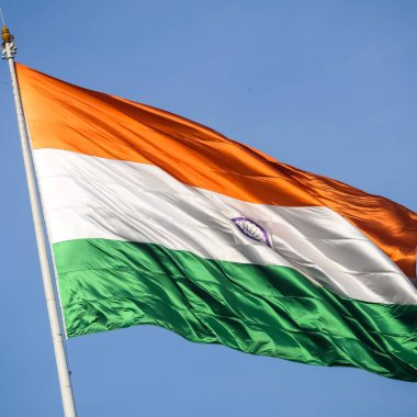 India flag flying high at Connaught Place with pride in blue sky, India flag fluttering, Indian Flag on Independence Day and Republic Day of India, tilt up shot, Waving Indian flag, Har Ghar Tiranga