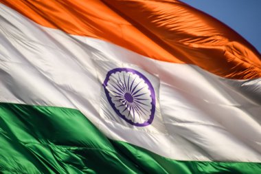 India flag flying high at Connaught Place with pride in blue sky, India flag fluttering, Indian Flag on Independence Day and Republic Day of India, tilt up shot, Waving Indian flag, Har Ghar Tiranga