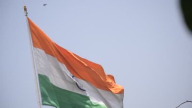 India flag flying high at Connaught Place with pride in blue sky, India flag fluttering, Indian Flag on Independence Day and Republic Day of India, tilt up shot, Waving Indian flag, Har Ghar Tiranga