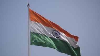 India flag flying high at Connaught Place with pride in blue sky, India flag fluttering, Indian Flag on Independence Day and Republic Day of India, tilt up shot, Waving Indian flag, Har Ghar Tiranga