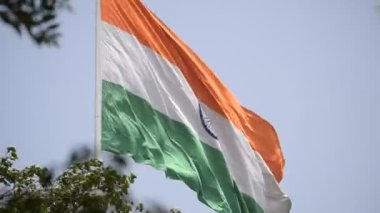 India flag flying high at Connaught Place with pride in blue sky, India flag fluttering, Indian Flag on Independence Day and Republic Day of India, tilt up shot, Waving Indian flag, Har Ghar Tiranga