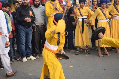 Delhi, India, November 17, 2024 - Sikhs display gatka and martial arts during annual Nagar Kirtan, Traditional, procession on account of birthday of Guru Nanak Dev ji, Nagar Kirtan in East Delhi area clipart