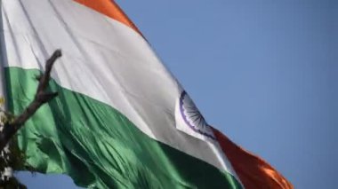 India flag flying high at Connaught Place with pride in blue sky, India flag fluttering, Indian Flag on Independence Day and Republic Day of India, tilt up shot, Waving Indian flag, Har Ghar Tiranga