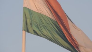India flag flying high at Connaught Place with pride in blue sky, India flag fluttering, Indian Flag on Independence Day and Republic Day of India, tilt up shot, Waving Indian flag, Har Ghar Tiranga