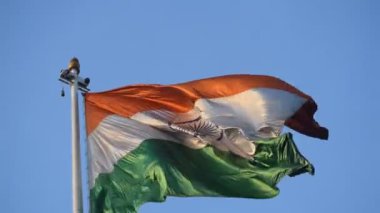 India flag flying high at Connaught Place with pride in blue sky, India flag fluttering, Indian Flag on Independence Day and Republic Day of India, tilt up shot, Waving Indian flag, Har Ghar Tiranga