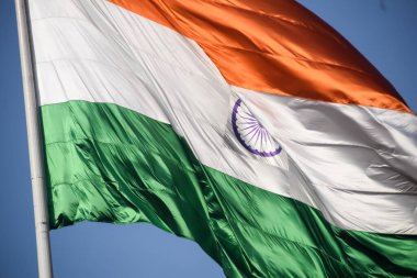 India flag flying high at Connaught Place with pride in blue sky, India flag fluttering, Indian Flag on Independence Day and Republic Day of India, tilt up shot, Waving Indian flag, Har Ghar Tiranga