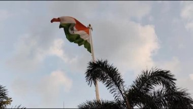 India flag flying high at Connaught Place with pride in blue sky, India flag fluttering, Indian Flag on Independence Day and Republic Day of India, tilt up shot, Waving Indian flag, Har Ghar Tiranga