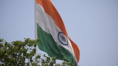 India flag flying high at Connaught Place with pride in blue sky, India flag fluttering, Indian Flag on Independence Day and Republic Day of India, tilt up shot, Waving Indian flag, Har Ghar Tiranga