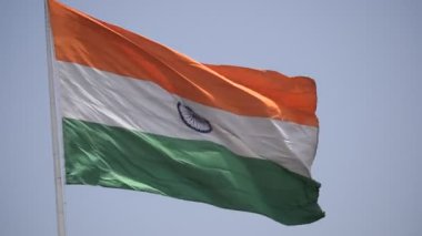 India flag flying high at Connaught Place with pride in blue sky, India flag fluttering, Indian Flag on Independence Day and Republic Day of India, tilt up shot, Waving Indian flag, Har Ghar Tiranga