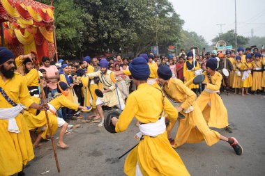Delhi, Hindistan, 17 Kasım 2024 - Doğu Delhi bölgesinde Guru Nanak Dev, Nagar Kirtan 'ın doğum günü dolayısıyla geleneksel Nagar Kirtan, geleneksel Nagar geçit töreninde Sihler gatka ve dövüş sanatlarını sergiliyor