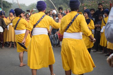 Delhi, India, November 17, 2024 - Sikhs display gatka and martial arts during annual Nagar Kirtan, Traditional, procession on account of birthday of Guru Nanak Dev ji, Nagar Kirtan in East Delhi area clipart