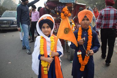 Delhi, India, November 17, 2024 - Sikhs display gatka and martial arts during annual Nagar Kirtan, Traditional, procession on account of birthday of Guru Nanak Dev ji, Nagar Kirtan in East Delhi area clipart