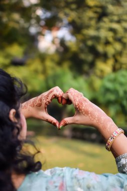 Beautiful woman dressed up as Indian tradition with henna mehndi design on her both hands to celebrate big festival of Karwa Chauth, Karwa Chauth celebrations by Indian woman for her husband clipart