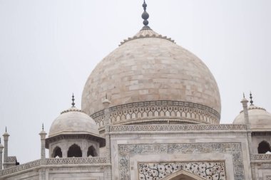 Amazing view of Taj Mahal which is among seven world wonders. Famous Indian Islamic heritage at cloudy day, Taj Mahal located at south bank of the Yamuna River clipart