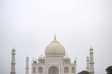 Amazing view of Taj Mahal which is among seven world wonders. Famous Indian Islamic heritage at cloudy day, Taj Mahal located at south bank of the Yamuna River clipart