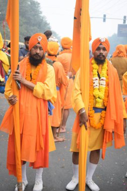 Delhi, Hindistan, 17 Kasım 2024 - Doğu Delhi bölgesinde Guru Nanak Dev, Nagar Kirtan 'ın doğum günü dolayısıyla geleneksel Nagar Kirtan, geleneksel Nagar geçit töreninde Sihler gatka ve dövüş sanatlarını sergiliyor