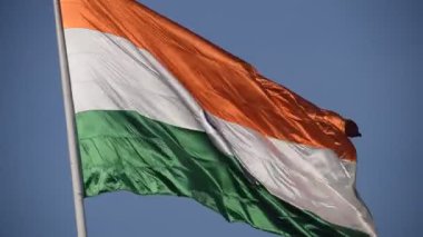 India flag flying high at Connaught Place with pride in blue sky, India flag fluttering, Indian Flag on Independence Day and Republic Day of India, tilt up shot, Waving Indian flag, Har Ghar Tiranga