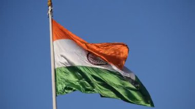 India flag flying high at Connaught Place with pride in blue sky, India flag fluttering, Indian Flag on Independence Day and Republic Day of India, tilt up shot, Waving Indian flag, Har Ghar Tiranga