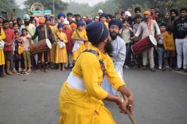 Delhi, India, November 17, 2024 - Sikhs display gatka and martial arts during annual Nagar Kirtan, Traditional, procession on account of birthday of Guru Nanak Dev ji, Nagar Kirtan in East Delhi area clipart