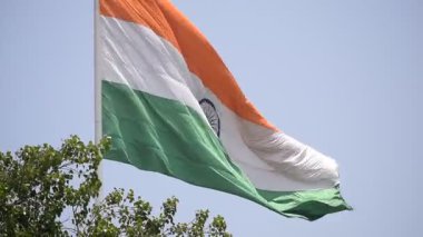 India flag flying high at Connaught Place with pride in blue sky, India flag fluttering, Indian Flag on Independence Day and Republic Day of India, tilt up shot, Waving Indian flag, Har Ghar Tiranga