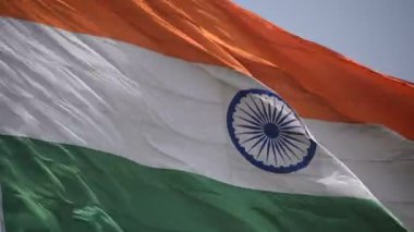 India flag flying high at Connaught Place with pride in blue sky, India flag fluttering, Indian Flag on Independence Day and Republic Day of India, tilt up shot, Waving Indian flag, Har Ghar Tiranga