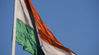 India flag flying high at Connaught Place with pride in blue sky, India flag fluttering, Indian Flag on Independence Day and Republic Day of India, tilt up shot, Waving Indian flag, Har Ghar Tiranga