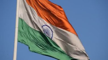 India flag flying high at Connaught Place with pride in blue sky, India flag fluttering, Indian Flag on Independence Day and Republic Day of India, tilt up shot, Waving Indian flag, Har Ghar Tiranga