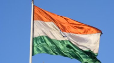India flag flying high at Connaught Place with pride in blue sky, India flag fluttering, Indian Flag on Independence Day and Republic Day of India, tilt up shot, Waving Indian flag, Har Ghar Tiranga