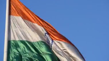 India flag flying high at Connaught Place with pride in blue sky, India flag fluttering, Indian Flag on Independence Day and Republic Day of India, tilt up shot, Waving Indian flag, Har Ghar Tiranga