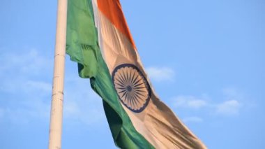 India flag flying high at Connaught Place with pride in blue sky, India flag fluttering, Indian Flag on Independence Day and Republic Day of India, tilt up shot, Waving Indian flag, Har Ghar Tiranga
