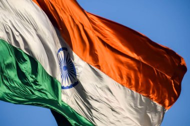 India flag flying high at Connaught Place with pride in blue sky, India flag fluttering, Indian Flag on Independence Day and Republic Day of India, tilt up shot, Waving Indian flag, Har Ghar Tiranga