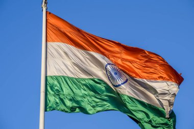 India flag flying high at Connaught Place with pride in blue sky, India flag fluttering, Indian Flag on Independence Day and Republic Day of India, tilt up shot, Waving Indian flag, Har Ghar Tiranga