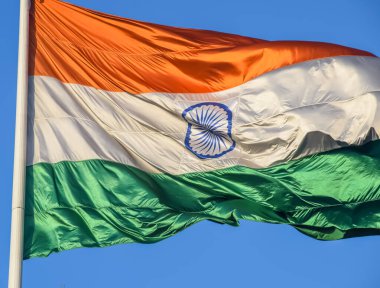 India flag flying high at Connaught Place with pride in blue sky, India flag fluttering, Indian Flag on Independence Day and Republic Day of India, tilt up shot, Waving Indian flag, Har Ghar Tiranga