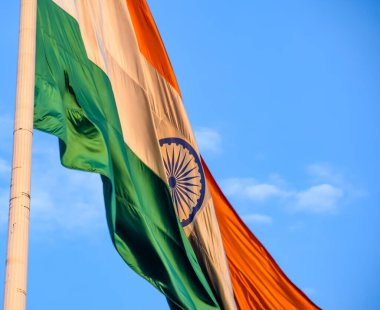 India flag flying high at Connaught Place with pride in blue sky, India flag fluttering, Indian Flag on Independence Day and Republic Day of India, tilt up shot, Waving Indian flag, Har Ghar Tiranga
