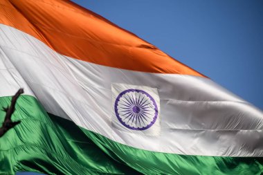 India flag flying high at Connaught Place with pride in blue sky, India flag fluttering, Indian Flag on Independence Day and Republic Day of India, tilt up shot, Waving Indian flag, Har Ghar Tiranga