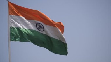 India flag flying high at Connaught Place with pride in blue sky, India flag fluttering, Indian Flag on Independence Day and Republic Day of India, tilt up shot, Waving Indian flag, Har Ghar Tiranga