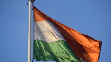 India flag flying high at Connaught Place with pride in blue sky, India flag fluttering, Indian Flag on Independence Day and Republic Day of India, tilt up shot, Waving Indian flag, Har Ghar Tiranga