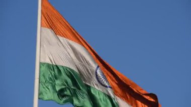 India flag flying high at Connaught Place with pride with plain white background, India flag fluttering, Indian Flag on Independence Day and Republic Day of India, tilt up shot, Har Ghar Tiranga