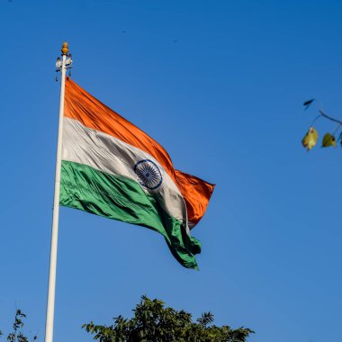 India flag flying high at Connaught Place with pride with plain white background, India flag fluttering, Indian Flag on Independence Day and Republic Day of India, tilt up shot, Har Ghar Tiranga