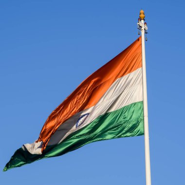 India flag flying high at Connaught Place with pride with plain white background, India flag fluttering, Indian Flag on Independence Day and Republic Day of India, tilt up shot, Har Ghar Tiranga