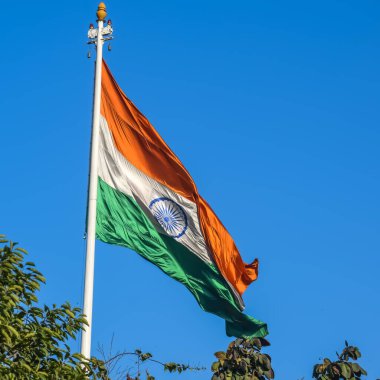 India flag flying high at Connaught Place with pride with plain white background, India flag fluttering, Indian Flag on Independence Day and Republic Day of India, tilt up shot, Har Ghar Tiranga