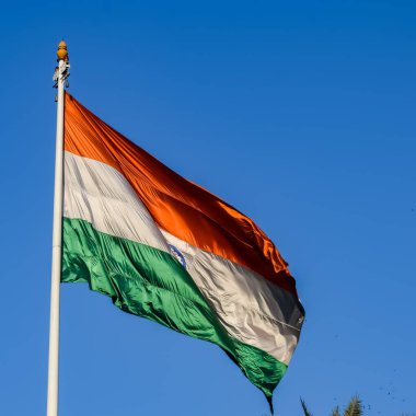 India flag flying high at Connaught Place with pride with plain white background, India flag fluttering, Indian Flag on Independence Day and Republic Day of India, tilt up shot, Har Ghar Tiranga