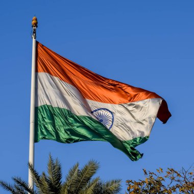 India flag flying high at Connaught Place with pride with plain white background, India flag fluttering, Indian Flag on Independence Day and Republic Day of India, tilt up shot, Har Ghar Tiranga