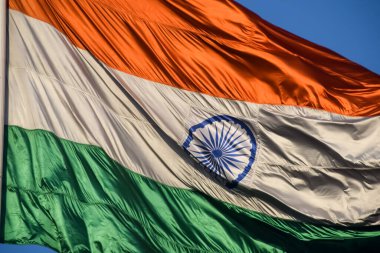 India flag flying high at Connaught Place with pride with plain white background, India flag fluttering, Indian Flag on Independence Day and Republic Day of India, tilt up shot, Har Ghar Tiranga